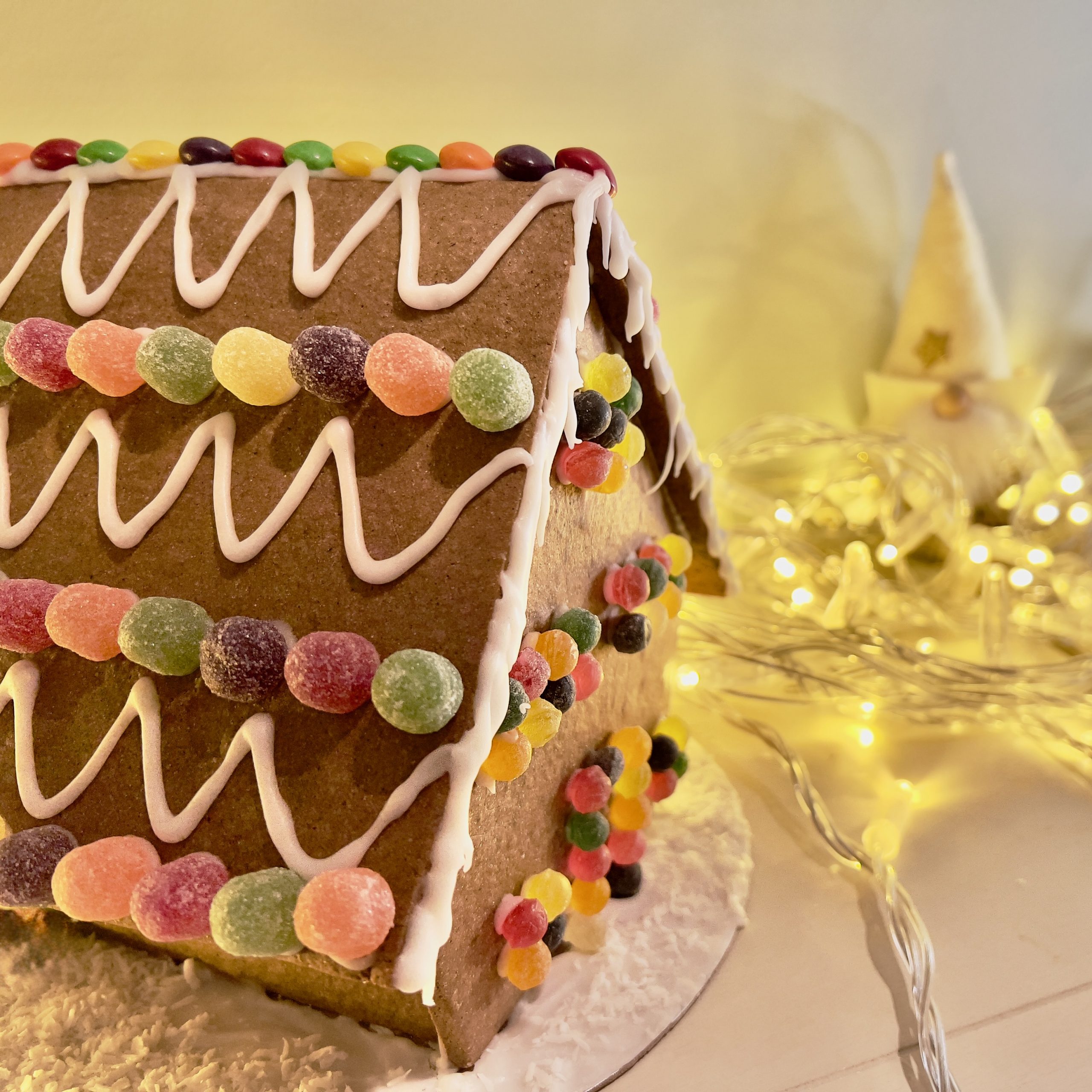 Gluten-free vegan gingerbread house - colourful Christmas design.