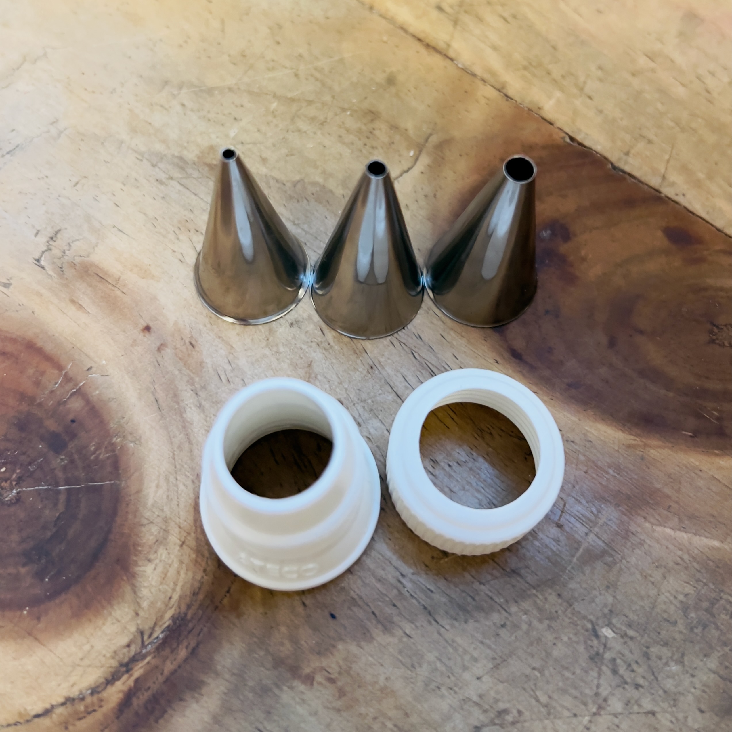 Three writing icing tips plus a coupler for easy removal of tips from the bag.